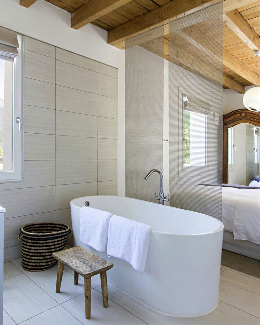 Master bedroom with freestanding bath and timber-beamed ceiling looking out to lake and mountains, Auld family build